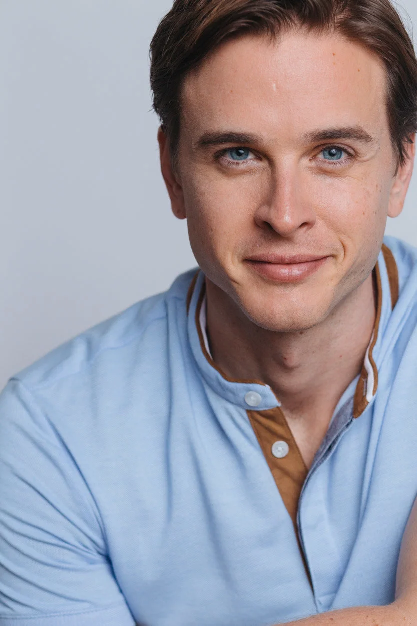 Grant Harling headshot, light blue polo