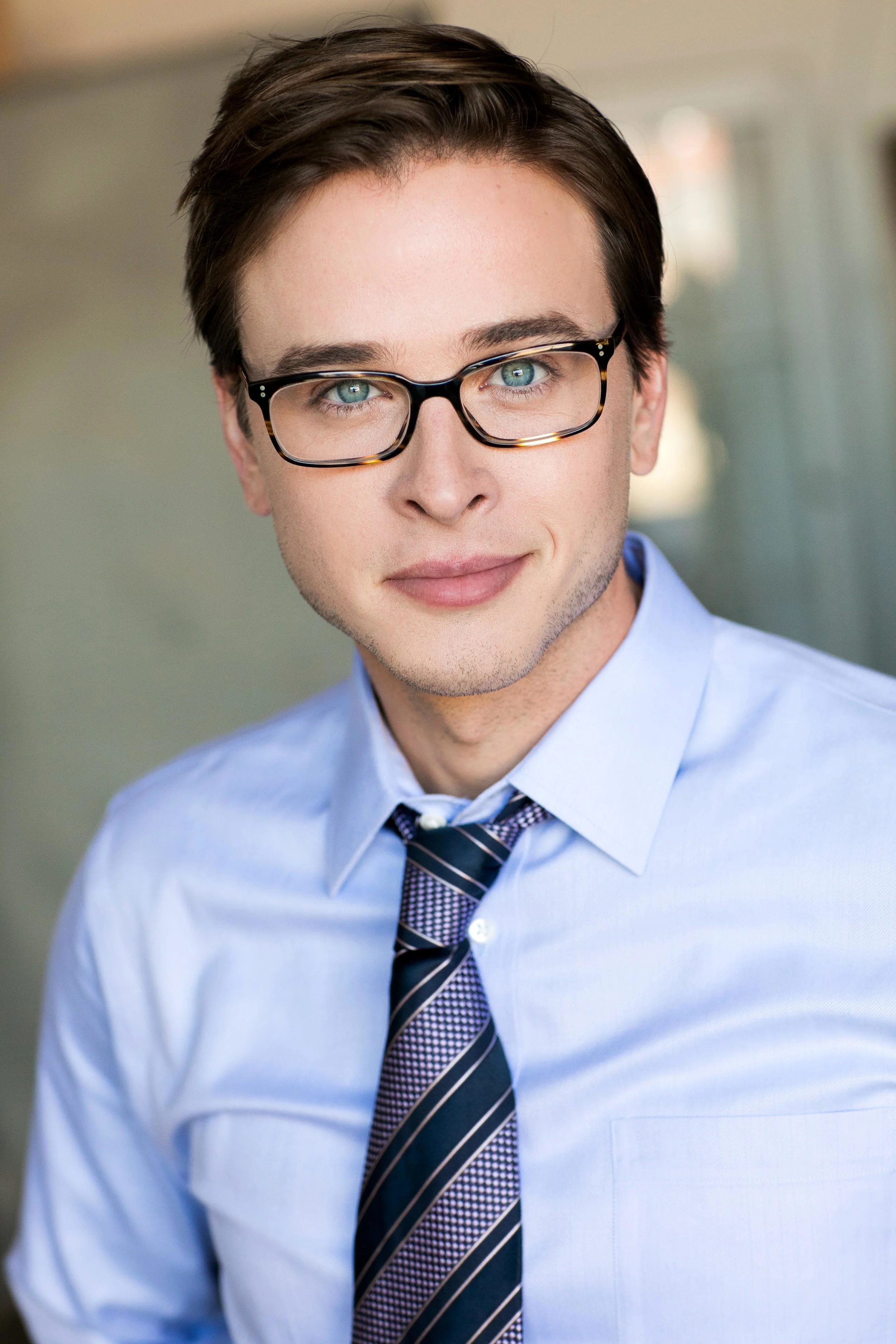 Grant Harling headshot, glasses and blue shirt with tie