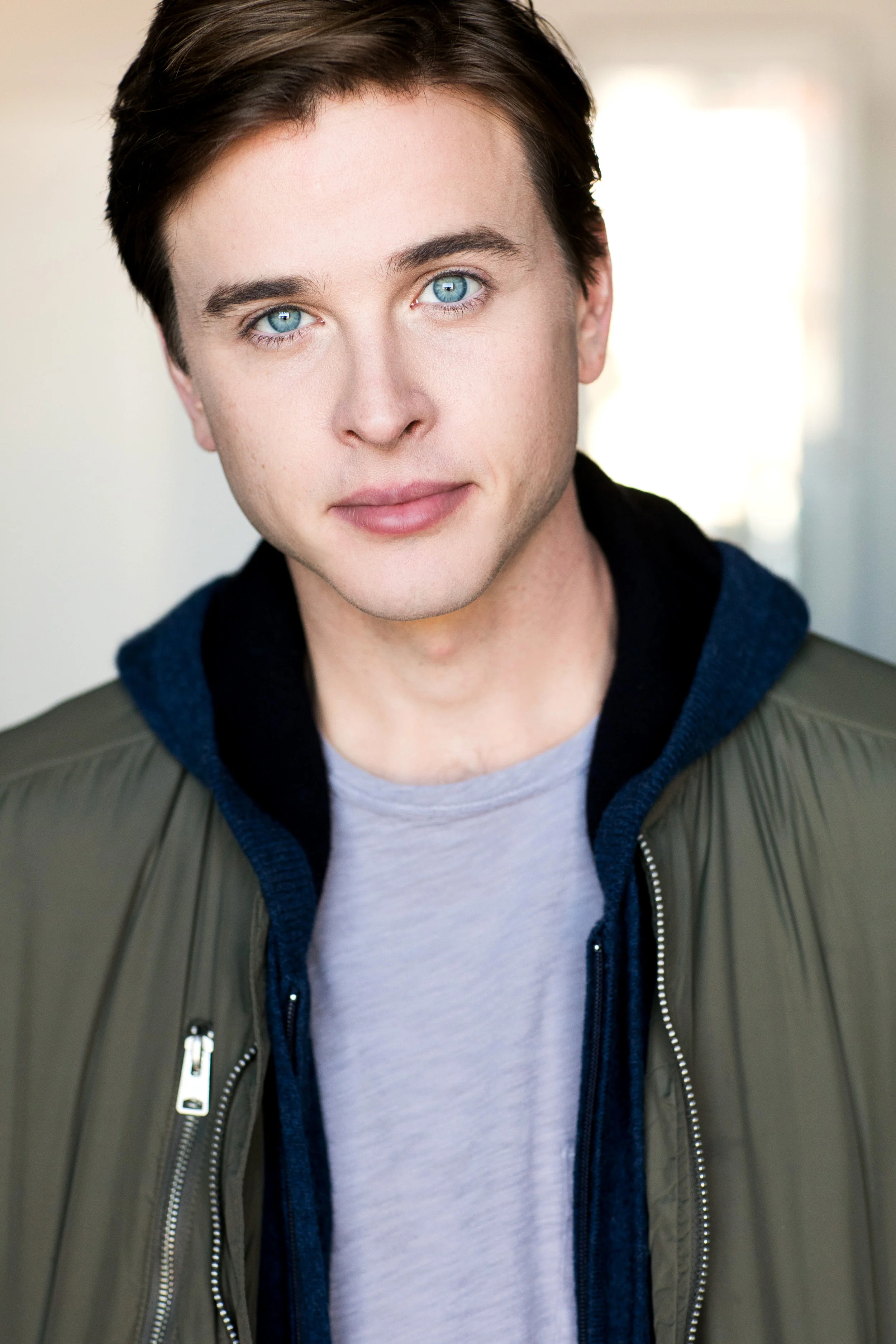 Grant Harling headshot, olive bomber jacket